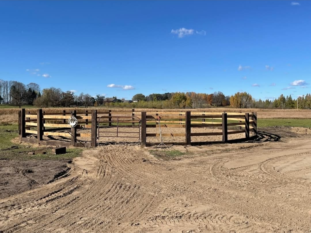 The 55-foot outdoor round pen under a clear sky