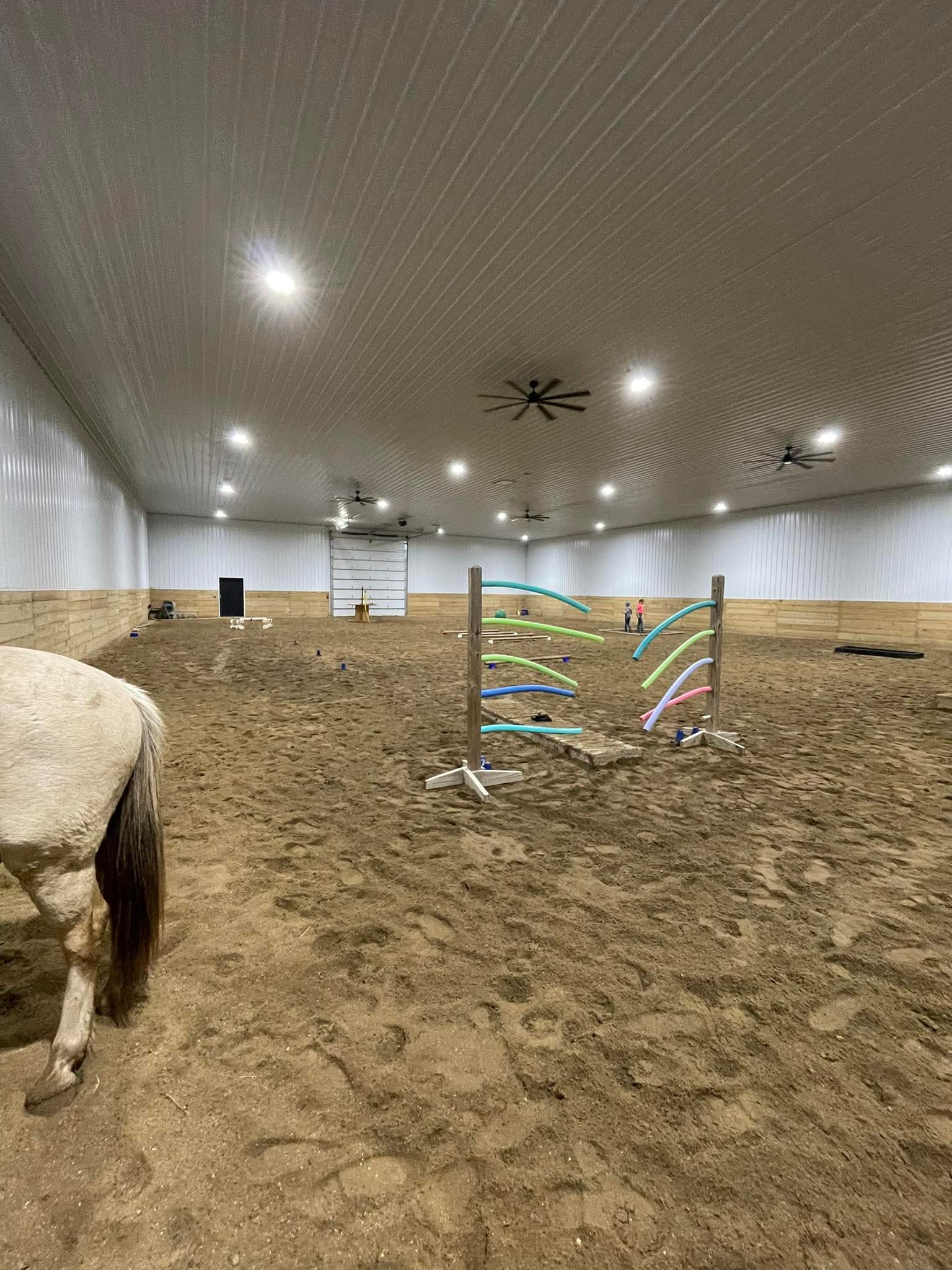 Inside the spacious indoor riding arena at Yahweh Arena